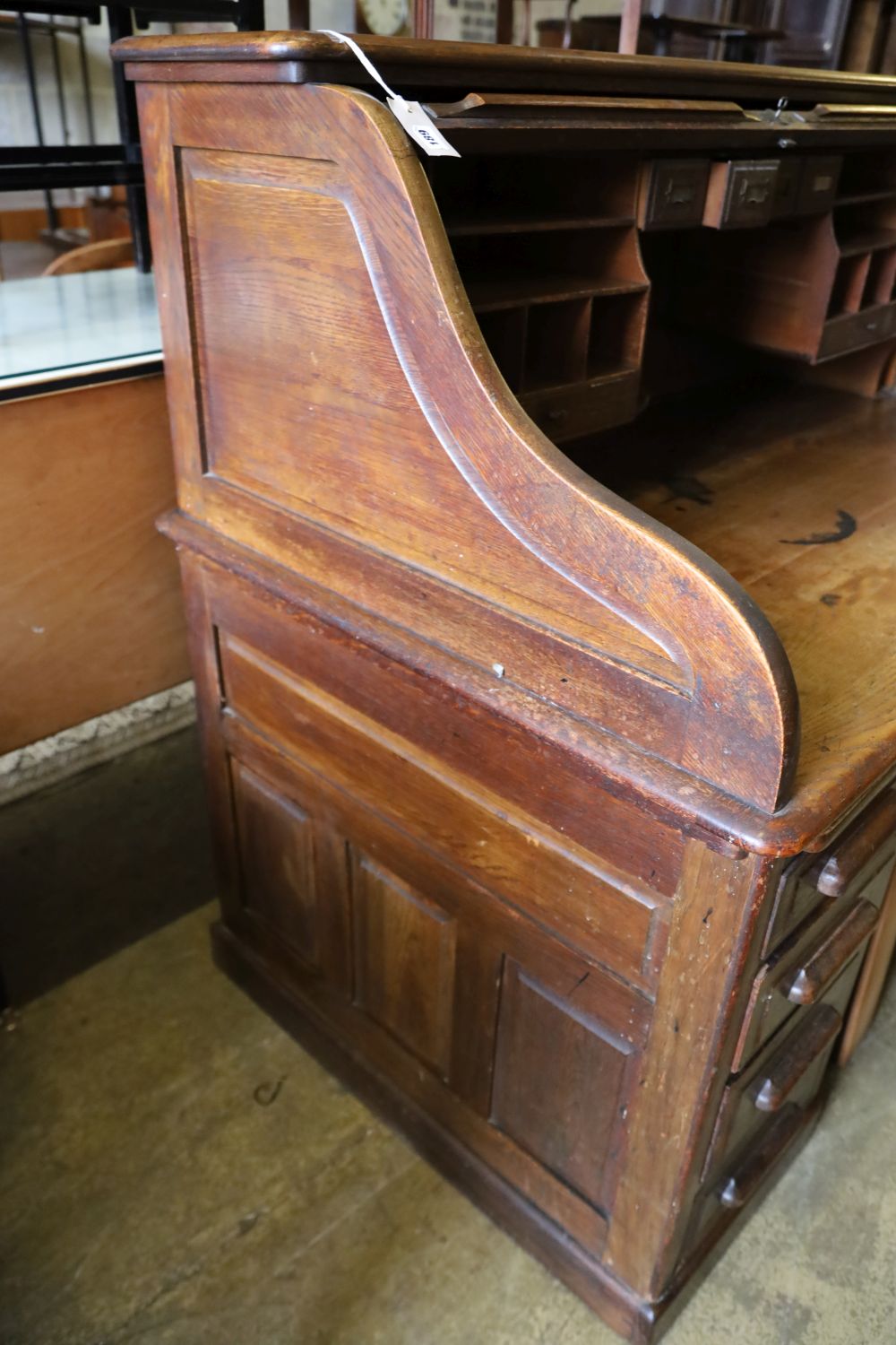 An oak roll-top desk, width 136cm, depth 86cm, height 126cm